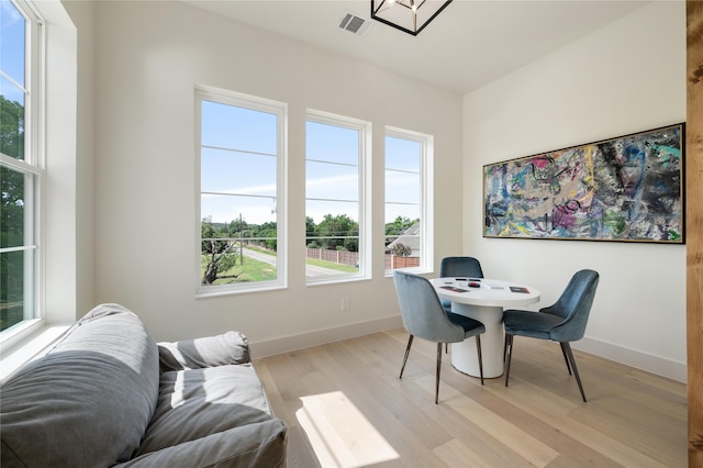 office with plenty of natural light and light wood-type flooring