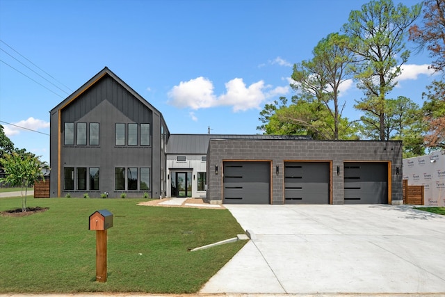 view of front of house with a front yard and a garage