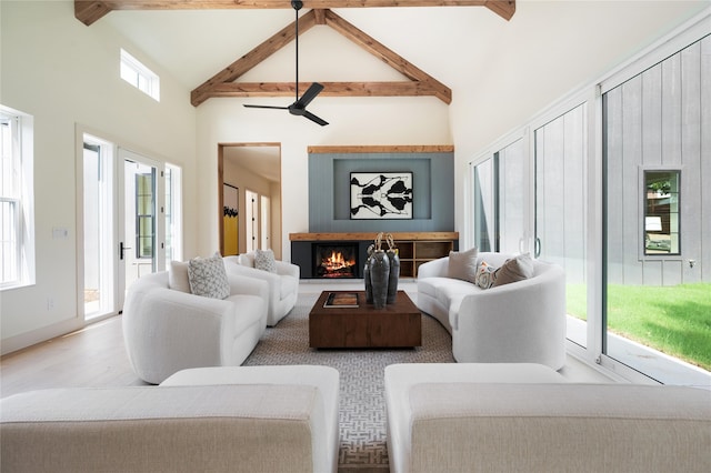 living room with beam ceiling, high vaulted ceiling, and ceiling fan