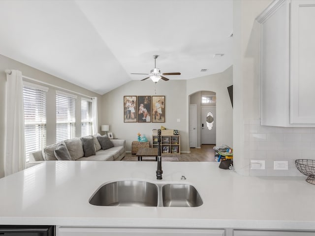 kitchen featuring light hardwood / wood-style flooring, white cabinets, sink, lofted ceiling, and ceiling fan