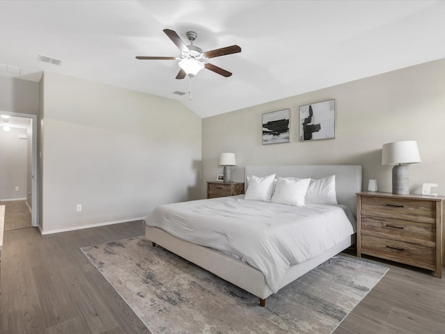 bedroom with ceiling fan, wood-type flooring, and lofted ceiling