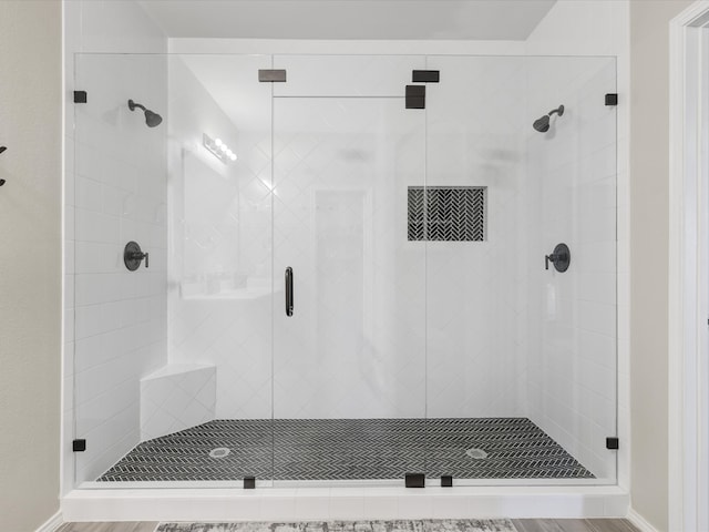 bathroom with wood-type flooring and a shower with shower door