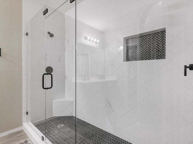 bathroom with an enclosed shower and hardwood / wood-style flooring