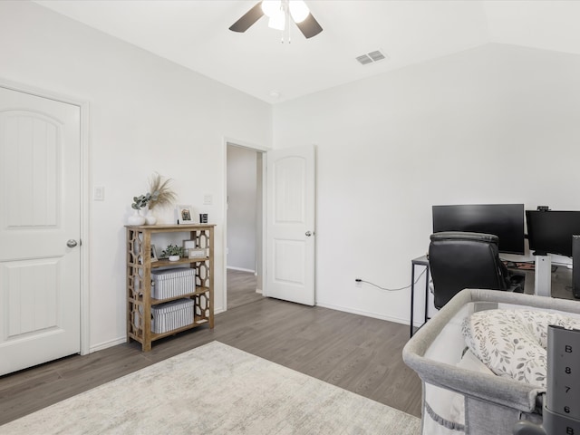 office area featuring dark hardwood / wood-style floors, vaulted ceiling, and ceiling fan