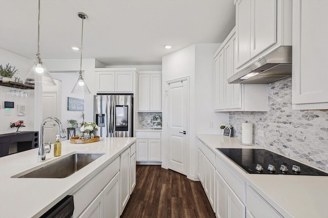 kitchen featuring sink, stainless steel fridge with ice dispenser, tasteful backsplash, decorative light fixtures, and white cabinetry