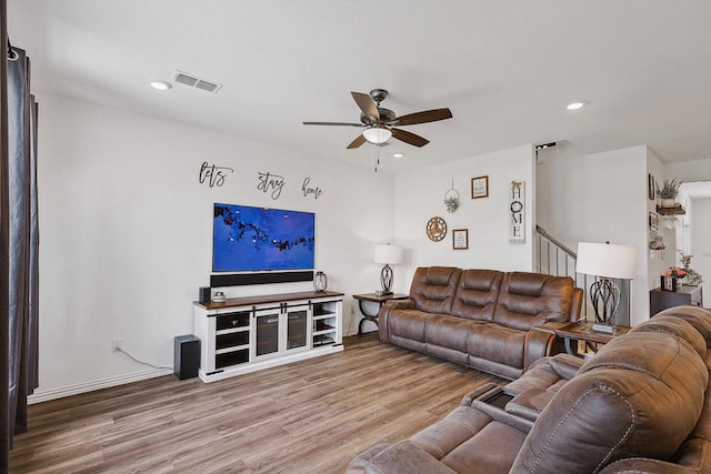 living room featuring hardwood / wood-style floors and ceiling fan