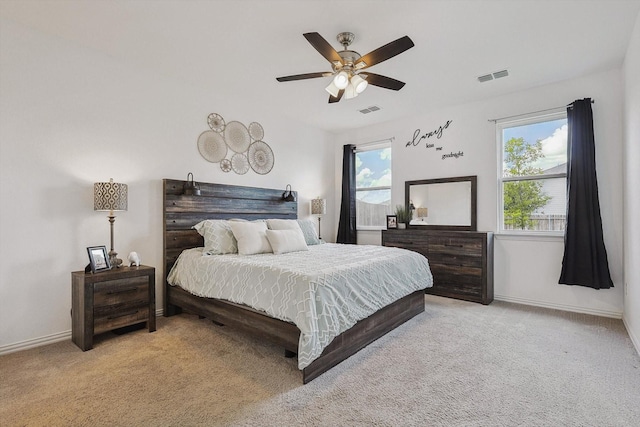 bedroom featuring ceiling fan and light carpet