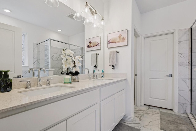 bathroom with vanity and a shower with shower door