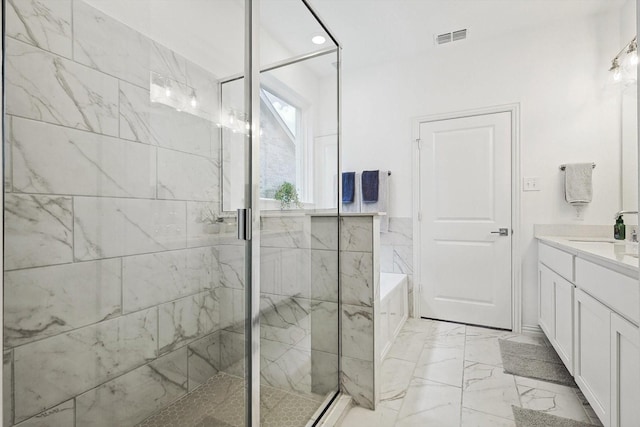 bathroom with vanity and separate shower and tub