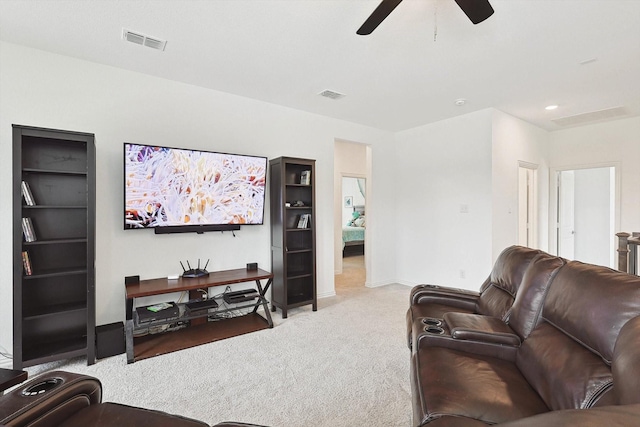 carpeted living room featuring ceiling fan