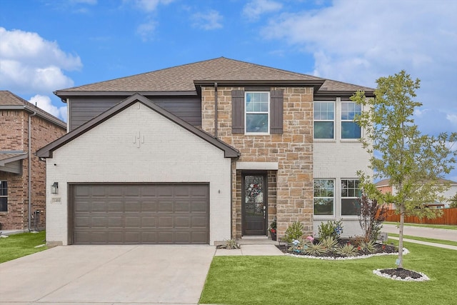 view of front of property featuring a front yard and a garage