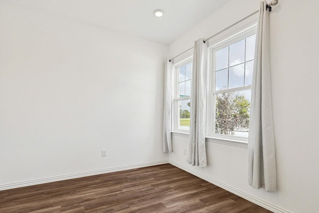 empty room with dark hardwood / wood-style flooring