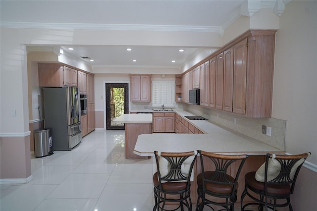 kitchen featuring kitchen peninsula, a kitchen breakfast bar, sink, and black appliances