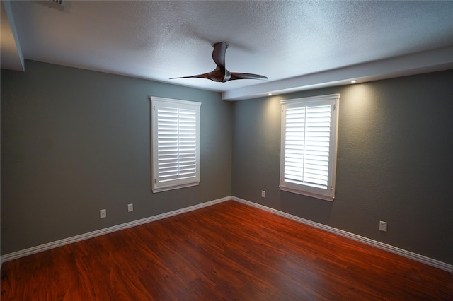 empty room featuring ceiling fan, wood-type flooring, and a textured ceiling