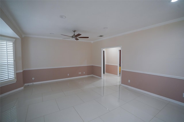 tiled empty room with ceiling fan and crown molding