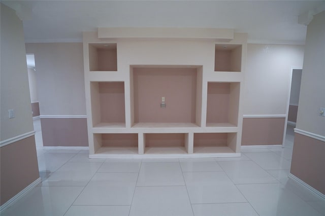 mudroom with light tile patterned floors, built in features, and crown molding