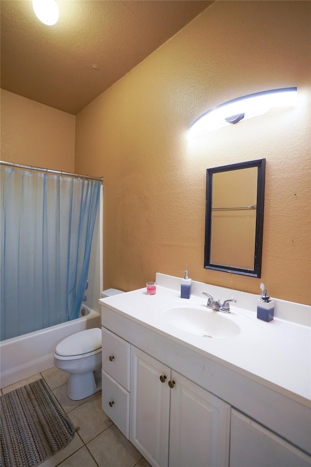 full bathroom featuring tile patterned floors, a textured ceiling, toilet, shower / bath combo with shower curtain, and vanity