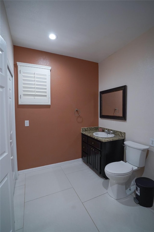 bathroom with tile patterned floors, vanity, and toilet