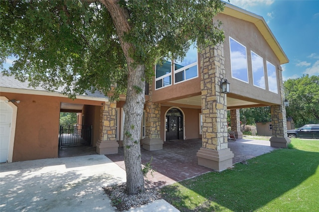 view of front facade with a front yard and french doors