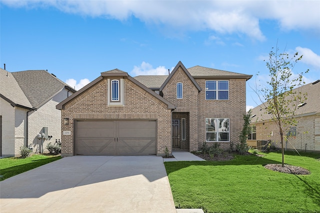 view of front of home with a front yard and a garage