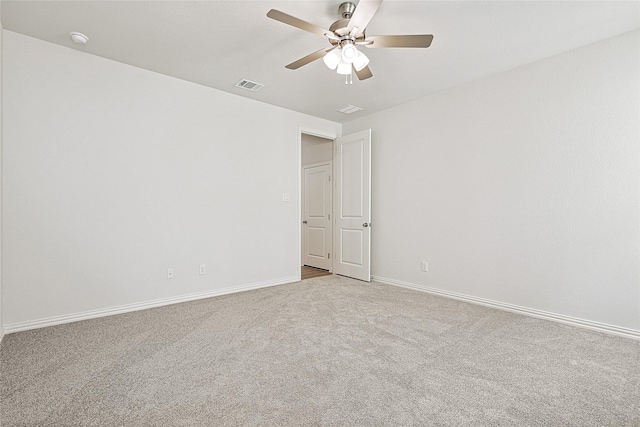 unfurnished room with ceiling fan and light carpet