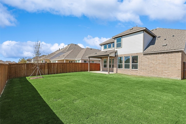 back of house featuring a patio area and a yard