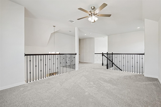 unfurnished room with ceiling fan, vaulted ceiling, and carpet