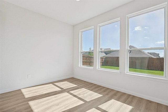 spare room with light wood-type flooring