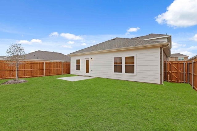 rear view of house with a yard and a patio area