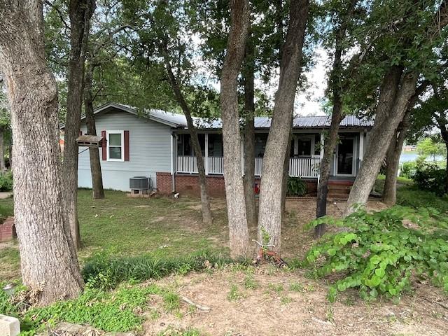 view of front of house with central AC unit and a porch