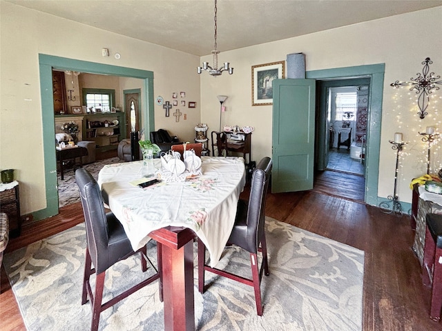 dining room featuring hardwood / wood-style flooring and a notable chandelier