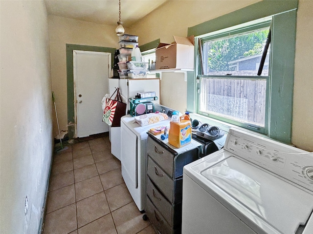 laundry area with light tile patterned floors and independent washer and dryer