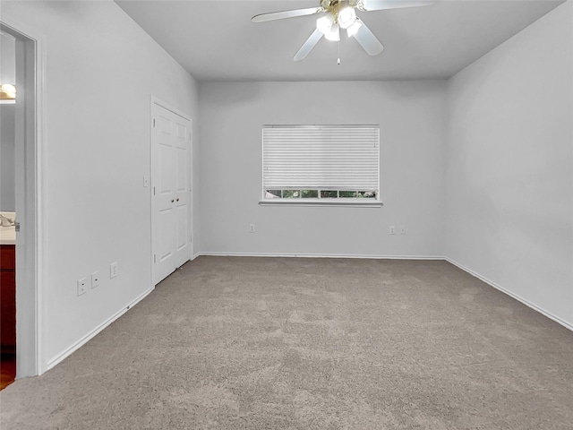 unfurnished bedroom featuring ceiling fan and carpet