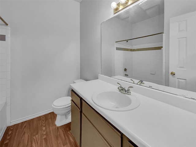 full bathroom with toilet, vanity, shower / washtub combination, and hardwood / wood-style floors