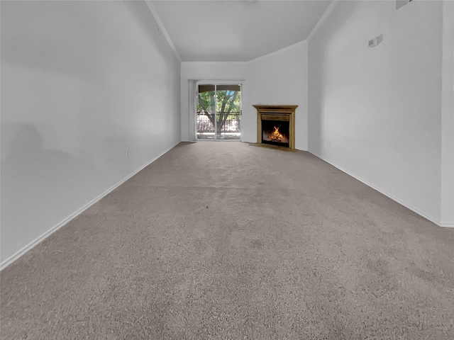 unfurnished living room featuring ornamental molding and carpet flooring