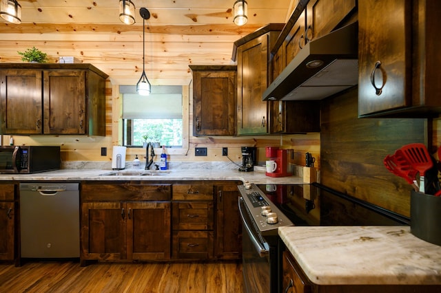 kitchen with dark hardwood / wood-style floors, range with electric cooktop, dishwasher, pendant lighting, and wooden walls