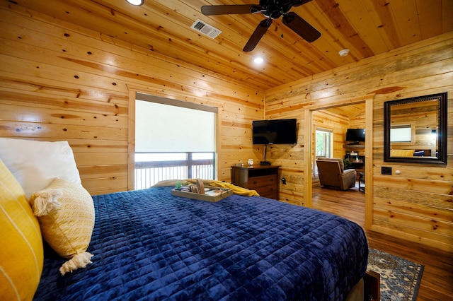 bedroom with wooden walls, ceiling fan, hardwood / wood-style floors, and wood ceiling