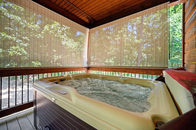 wooden deck with a hot tub