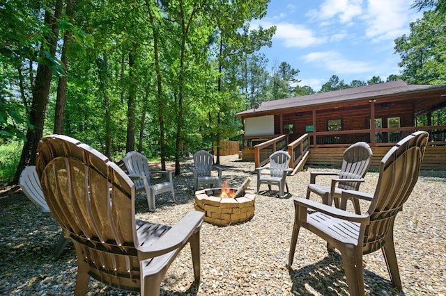 view of terrace with a deck and a fire pit