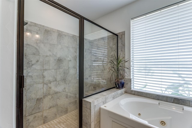 bathroom featuring separate shower and tub