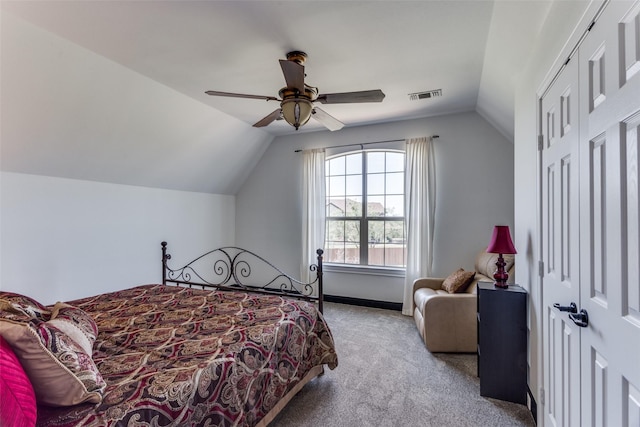 bedroom with ceiling fan, vaulted ceiling, and light carpet