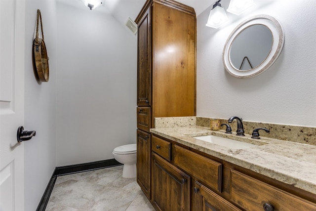 bathroom featuring vanity and toilet