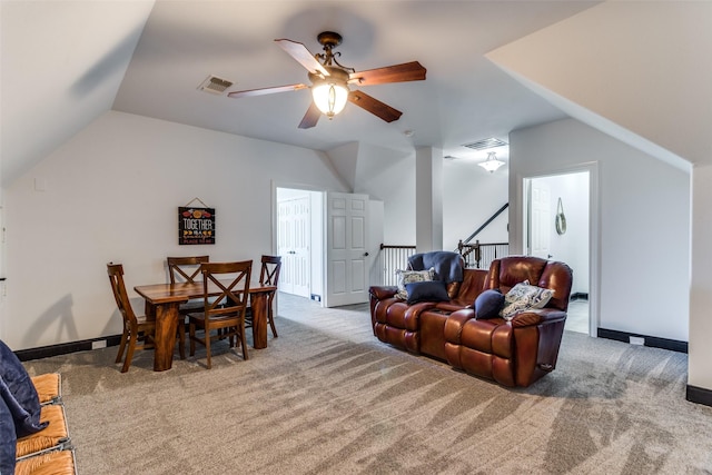 living room featuring lofted ceiling, light colored carpet, and ceiling fan