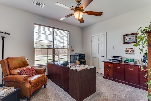 office space featuring ceiling fan and light carpet