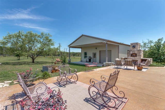 view of patio / terrace featuring area for grilling and an outdoor stone fireplace