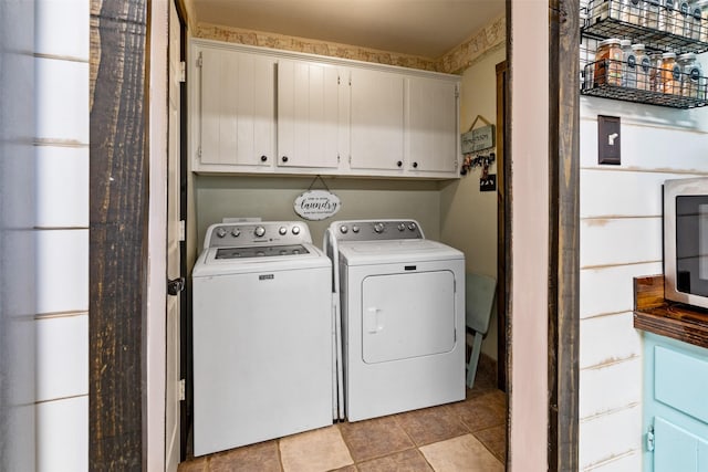 laundry area with washing machine and dryer and cabinets