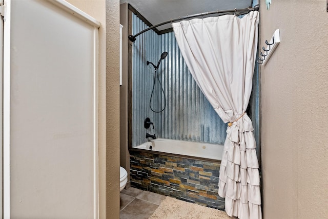 bathroom with toilet, tile patterned flooring, and shower / tub combo with curtain