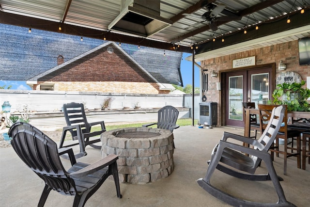 view of patio / terrace with ceiling fan, french doors, and an outdoor fire pit