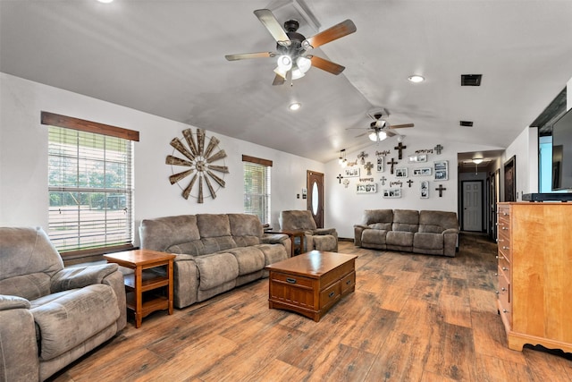 living room with dark hardwood / wood-style flooring, ceiling fan, and lofted ceiling