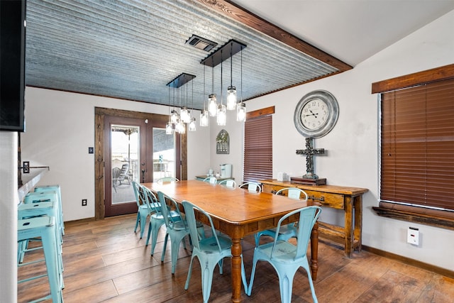 dining space with lofted ceiling, dark wood-type flooring, and french doors